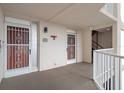 Exterior hallway with security doors, unit number 312, and staircase access offering safety and convenience at 5980 Shore S Blvd # 312, Gulfport, FL 33707