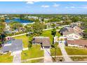 Aerial view of the property showcasing the neighborhood, nearby lake, and lush green surroundings at 6070 Denver Ne St, St Petersburg, FL 33703