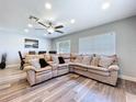 Comfortable living room features a large sectional sofa, recessed lighting, ceiling fan, and dining area at 6811 S Himes Ave, Tampa, FL 33611