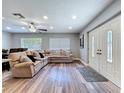 A cozy living room is shown featuring a large sectional couch and elegant double door entryway at 6811 S Himes Ave, Tampa, FL 33611