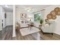 Cozy living room featuring hardwood floors, a comfortable sofa, and stylish decor at 7000 14Th N St, St Petersburg, FL 33702