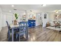 Bright, open-concept living and dining area features hardwood floors and a breakfast bar at 7000 14Th N St, St Petersburg, FL 33702
