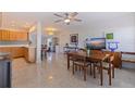This room features terrazzo flooring, a ceiling fan, and plenty of natural light from the windows at 725 85Th N Ave, St Petersburg, FL 33702