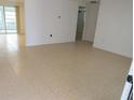 Open concept living room featuring tile flooring and neutral color palette at 7534 Mako Dr, Hudson, FL 34667
