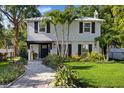Charming two-story home featuring a manicured front yard, paver walkway, and inviting entrance at 8020 Sharon Dr, Tampa, FL 33617