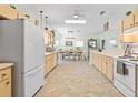 Bright kitchen featuring a spacious layout, skylight, extensive cabinetry, and adjacent dining area, perfect for Gathering gatherings at 9019 Stone Dr, Webster, FL 33597