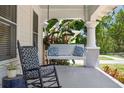 Inviting front porch with swing, rocking chair, and ample space for relaxation at 906 E Patterson St, Tampa, FL 33604