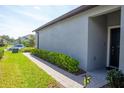 Landscaped front yard with brick walkway and lush green lawn leading to the front door at 9943 Campanula Ct, Land O Lakes, FL 34637