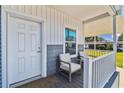 Relaxing front porch with seating area and stylish decor perfect for enjoying the outdoors at 10029 Wellington Ave, Dade City, FL 33525