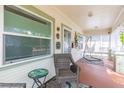 Relaxing covered porch featuring seating, neutral colors, and plenty of natural light at 1008 E 25Th Ave, Tampa, FL 33605