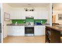 Bright kitchen featuring modern stainless steel appliances and granite countertops at 1008 E 25Th Ave, Tampa, FL 33605