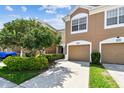 Charming townhouse with a two-car garage, tidy landscaping, and a well-maintained lawn at 10135 Post Harvest Dr, Riverview, FL 33578