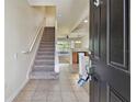 Inviting foyer with staircase and views of the kitchen and living areas at 10135 Post Harvest Dr, Riverview, FL 33578