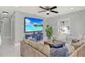 Spacious living room featuring a comfortable sofa, modern decor, and a large TV for entertaining at 10218 Lola St, Tampa, FL 33612