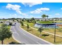 Wide aerial shot of the community entrance, lush landscaping, and surrounding neighborhood streets at 11443 Cay Spruce Way, San Antonio, FL 33576