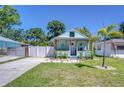 Charming blue cottage with a well-manicured front yard and inviting curb appeal at 1240 Georgia Ave, Dunedin, FL 34698