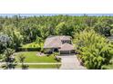 Expansive aerial view showcases the home, landscaped yard, and surrounding lush greenery at 12801 Castlemaine Dr, Tampa, FL 33626