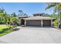 Spacious three-car garage with stone accents and a wide driveway for easy access at 12801 Castlemaine Dr, Tampa, FL 33626