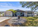 Charming single Gathering home with new paint, a nice front yard and lovely curb appeal at 1344 Dartmouth Dr, Holiday, FL 34691