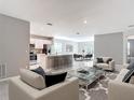 Open-concept living space featuring a modern kitchen with a breakfast bar seamlessly connected to the cozy living area at 14020 Sooty Tern Ave, Brooksville, FL 34614