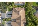 An aerial view of a property, showcasing the roofline, driveway, and landscaping at 14418 Mirabelle Vista Cir, Tampa, FL 33626