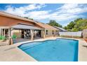 Swimming pool with a paved deck and covered seating area, ideal for relaxation and outdoor enjoyment at 1536 Norwick Dr, Lutz, FL 33559