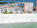 Wide aerial view of condos on a white sand beach near the ocean and intracoastal at 17960 Gulf Blvd # 111, Redington Shores, FL 33708