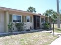 Charming condo showcasing tidy front lawn and screened in entrance for relaxed outdoor living at 1942 Settlement Rd # 25, Venice, FL 34285