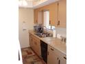 Cozy kitchen with warm toned cabinets, updated appliances, and ample counter space at 1942 Settlement Rd # 25, Venice, FL 34285