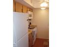 Efficient kitchen features white refrigerator, matching stove, and built-in microwave at 1942 Settlement Rd # 25, Venice, FL 34285