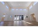 Expansive living room showcases high ceilings, abundant natural light and wood-look flooring at 233 45Th Ave, St Pete Beach, FL 33706