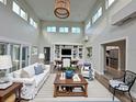 Bright, airy living room featuring high ceilings, clerestory windows and white sofas in a neutral color palette at 233 45Th Ave, St Pete Beach, FL 33706