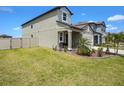 Spacious side yard with lush green grass and partial fencing, ideal for outdoor activities at 2870 Silver Scallop Dr, Wimauma, FL 33598