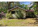 Charming home featuring neat landscaping, plants, and a quaint exterior at 29133 Lawton Dr, Nobleton, FL 34661