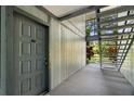Exterior entrance features a secure front door and stairs to access the second level unit at 3241 Fox Chase N Cir # 106, Palm Harbor, FL 34683
