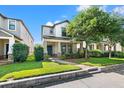 Charming two-story home featuring a covered porch, well-manicured landscaping, and a brick pathway at 4194 Bexley Village Dr, Land O Lakes, FL 34638