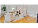 Bright living room featuring hardwood floors, neutral furniture, and large windows at 4301 W Swann Ave, Tampa, FL 33609