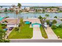 Charming single-story home with a well-manicured lawn and a long driveway at 525 Lillian Dr, Madeira Beach, FL 33708