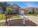 A cozy two-story home with an attached garage and a well-kept lawn on a sunny day at 6616 Northhaven Ct, Riverview, FL 33578