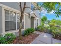 View of the front yard and entry, featuring a well-manicured lawn and mature landscaping at 6851 Breezy Palm Dr, Riverview, FL 33578