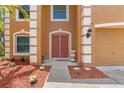 Inviting entryway with a double door and decorative landscaping enhancing curb appeal at 7102 W Creek Dr, Tampa, FL 33615