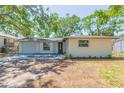 Inviting single-story house showcasing a well-maintained lawn, painted exterior, and an attached one car garage at 7409 S Obrien St, Tampa, FL 33616
