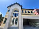 Exterior shot of a modern two-story home showcasing a soaring peaked roofline and two car garage at 812 W Braddock St, Tampa, FL 33603