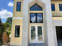 Close-up of the front entrance featuring double doors, tall windows, and modern stone columns at 812 W Braddock St, Tampa, FL 33603