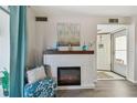 Inviting fireplace in living room with decorative mantel and adjacent seating area at 854 Sky Loch N Dr, Dunedin, FL 34698
