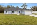 Charming single-story home with a paved driveway, attached garage, and well-manicured lawn at 10262 Maybird Ave, Weeki Wachee, FL 34613