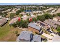 Wide aerial shot of house and neighboring houses, highlighting proximity to local lake at 11449 Crestlake Village Dr, Riverview, FL 33569