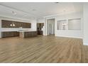 Expansive living room featuring an open floor plan, light wood floors and tray ceilings at 13052 Homestead Ln, Parrish, FL 34219