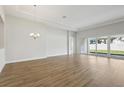 Bright living room with sliding glass doors and hardwood floors at 13052 Homestead Ln, Parrish, FL 34219