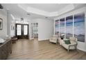 Inviting living room showcasing neutral paint, plenty of natural light, and an ocean-themed art feature at 15229 Wind Whisper Dr, Odessa, FL 33556